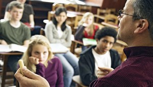 Over the shoulder view of students listening to teacher